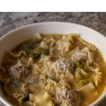 Easy make-ahead meatballs and escarole soup made with chicken broth, lemon zest, and parmesan, with mini meatballs and chopped escarole.