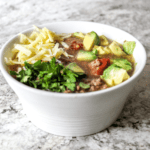 Brothy and comforting, this soup boasts red onion, garlic, black beans, browned ground beef, and is seasoned with packaged taco seasoning.