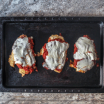 Chicken parm made on a sheet pan, prepped ahead of time, too! Crispy chicken smothered in zesty quick-made marinara and melty mozzarella.
