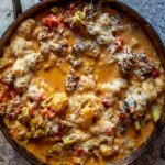 Creamy, cheesy skillet gnocchi cooked with crumbled sausage, and broccoli florets, and topped with a shower of parmesan cheese.
