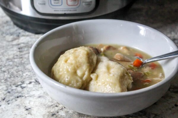 Instant Pot Chicken & Dumplings, with a creamy base, hearty vegetables, southern-style dumplings, tender bites of chicken- in under an hour!