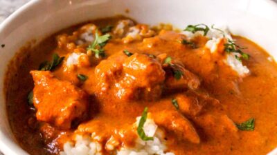 Homemade Indian Butter Curry made with tomato sauce, curry seasonings, and served over jasmine rice. Makes a great freezer meal!