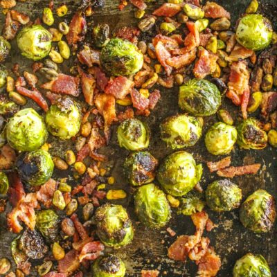 Sheet pan brussels sprouts with crunchy pistachios and crumbly salty bacon. Makes a great side dish or Thanksgiving recipe!