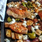 Greek chicken sheet pan meal with spice-rubbed chicken, buttery green olives, roasted eggplant, finished with a sprinkle of feta.