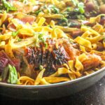 Seared tomato and honey chicken with spinach and red onion, all swirled together with fettuccine pasta for an easy one-pan weeknight meal!