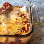 Weeknight recipe for great leftovers! Tender strip steak rolled in flour tortillas, smothered in a homemade enchilada sauce and melty cheese.