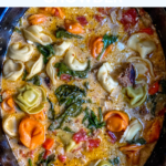 Creamy, smooth, and easy; slow cooker tortellini soup made with sausage, cream cheese, fresh spinach, diced tomatoes, and cheese tortellini.